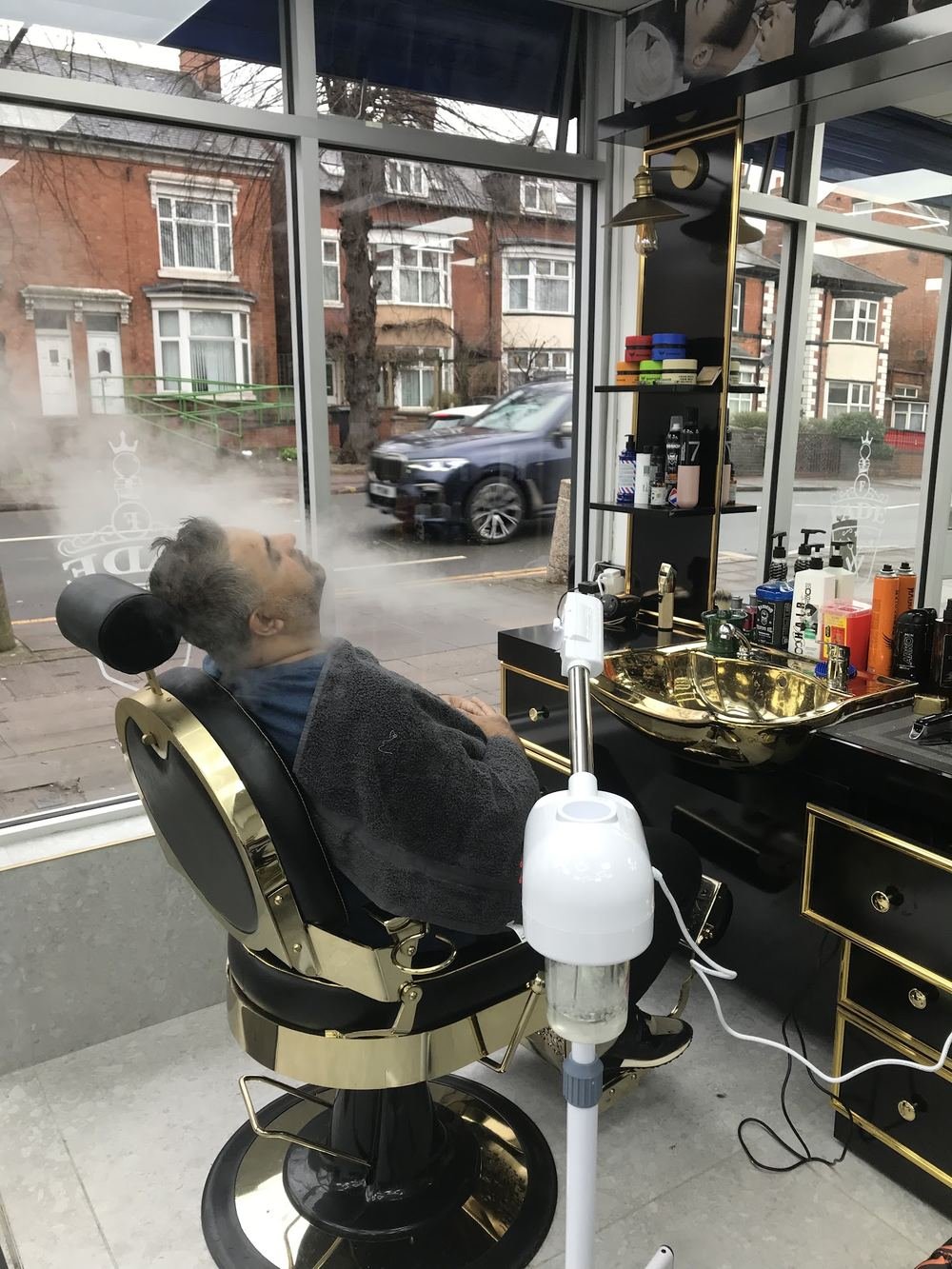 A customer having face steaming in the chair